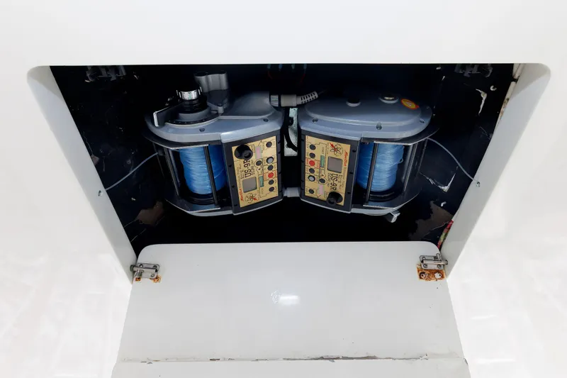 Slide: The Image of 2002 Albemarle 41 Express Fisherman fishing equipment compartment with dual reels. - 28