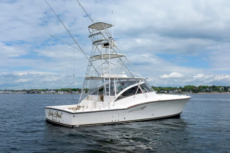 Slide: The Image of 2002 Albemarle 41 Express Fisherman boat on calm water under a cloudy sky. - 3