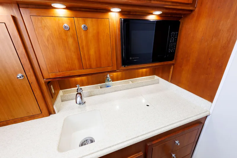 Slide: The Image of Luxurious kitchen area in 2002 Albemarle 41 Express Fisherman boat with wood cabinets and modern appliances. - 32