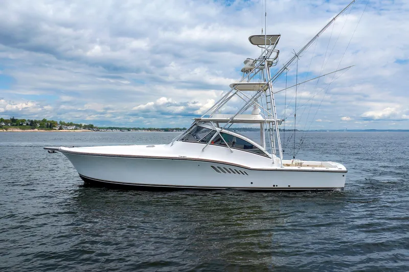 Slide: The Image of 2002 Albemarle 41 Express Fisherman boat on calm water under cloudy sky. - 4