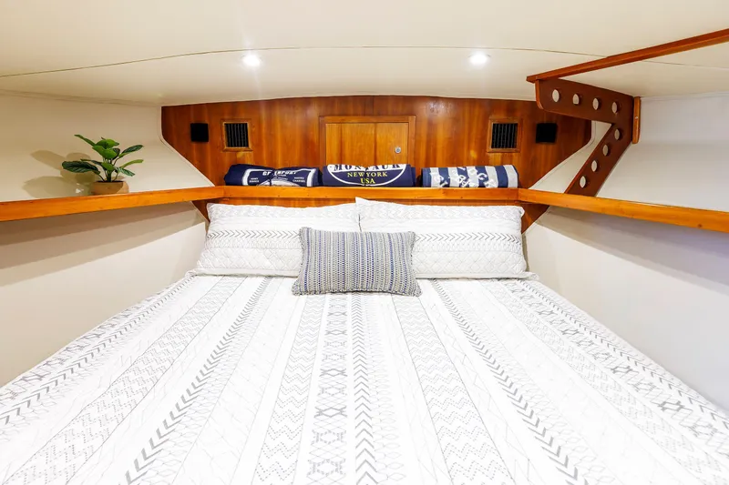Slide: The Image of Cozy cabin interior of 2002 Albemarle 41 Express Fisherman with patterned bedding and wooden accents. - 40
