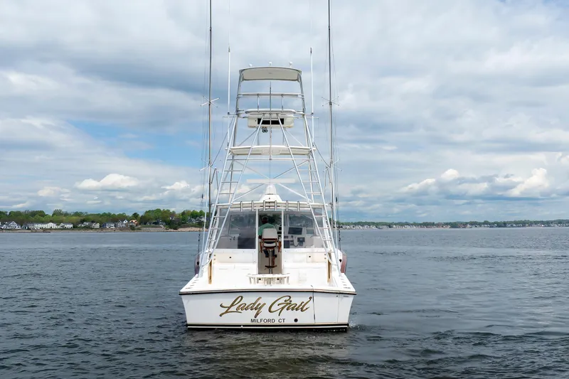 Slide: The Image of 2002 Albemarle 41 Express Fisherman boat on calm water, rear view. - 5