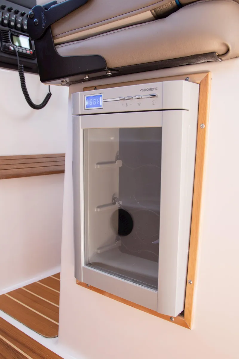 Slide: The Image of Built-in refrigerator on 2025 Cutwater 32 Coupe boat interior. - 11