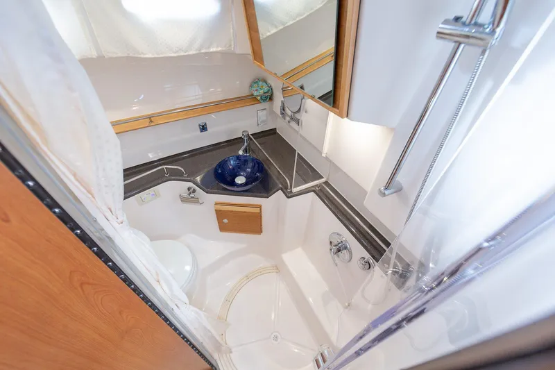 Slide: The Image of 2025 Cutwater 32 Coupe bathroom with modern fixtures and blue sink. - 7