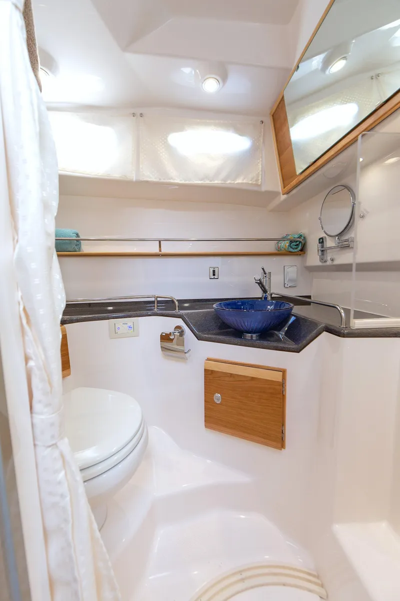 Slide: The Image of 2025 Cutwater 32 Coupe bathroom with modern fixtures and blue sink. - 8