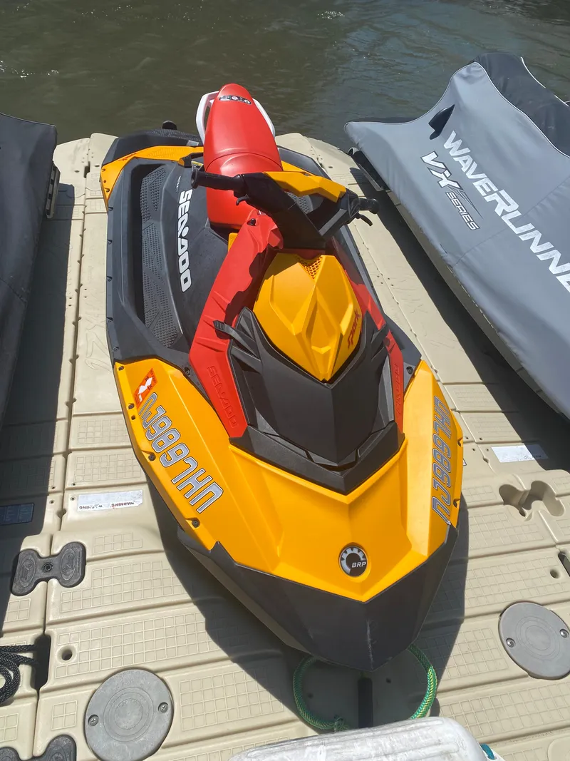 Slide: The Image of 2022 Sea-Doo Spark 3up jet ski in vibrant yellow and red on a dock. - 4