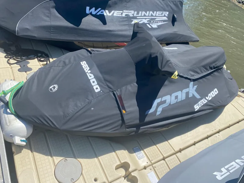 Slide: The Image of 2022 Sea-Doo Spark 3up jet ski covered on dock, ready for water adventure. - 5