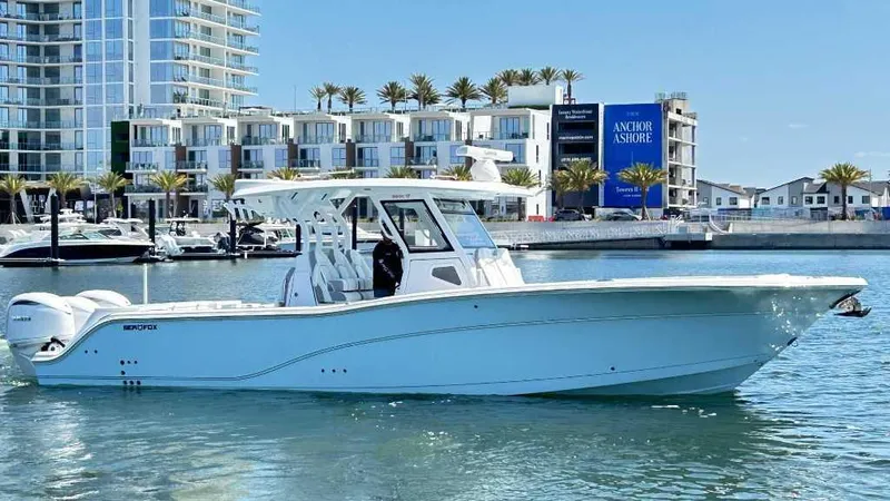 Slide: The Image of 2026 Sea Fox 368 Commander boat docked near modern waterfront buildings. - 1