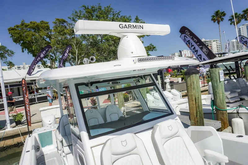 Slide: The Image of 2026 Sea Fox 368 Commander boat docked, featuring Garmin equipment, in a sunny marina setting. - 17
