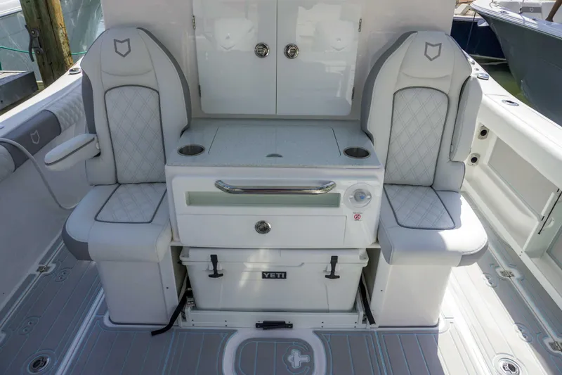 Slide: The Image of 2026 Sea Fox 368 Commander boat interior with cushioned seating and storage. - 18