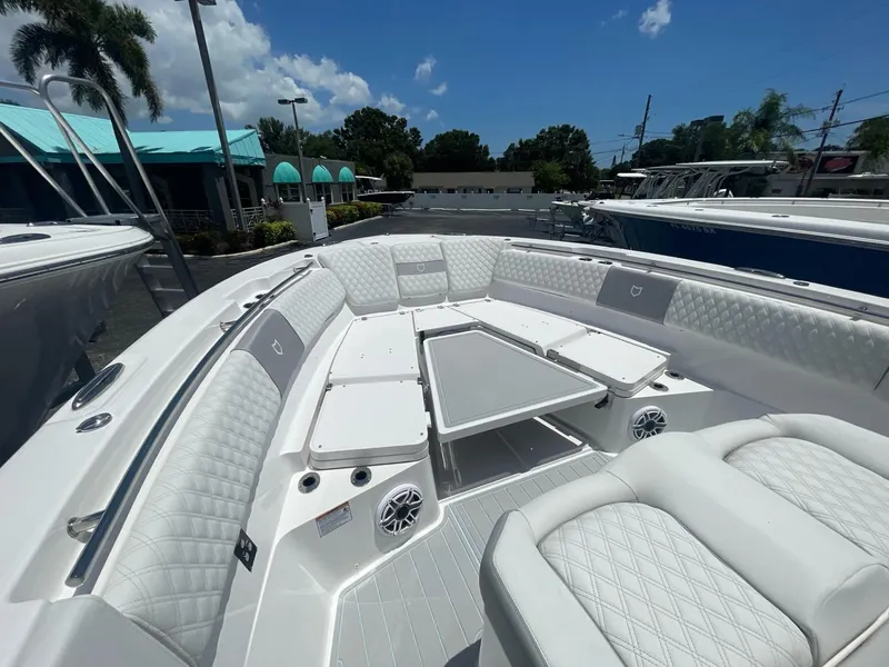 Slide: The Image of 2026 Sea Fox 368 Commander boat interior with luxurious seating and table under a sunny sky. - 28
