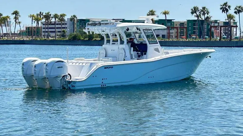 Slide: The Image of 2026 Sea Fox 368 Commander boat on water with palm trees in background. - 4