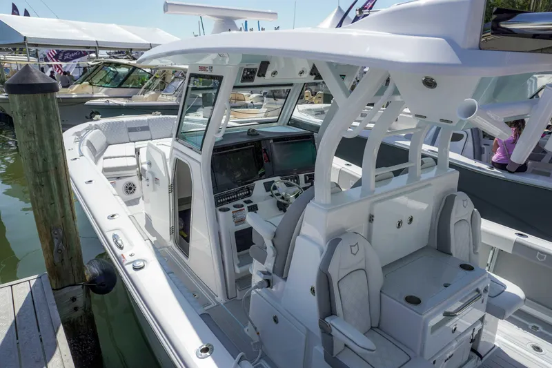 Slide: The Image of 2026 Sea Fox 368 Commander boat with sleek design and modern cockpit at a marina. - 9