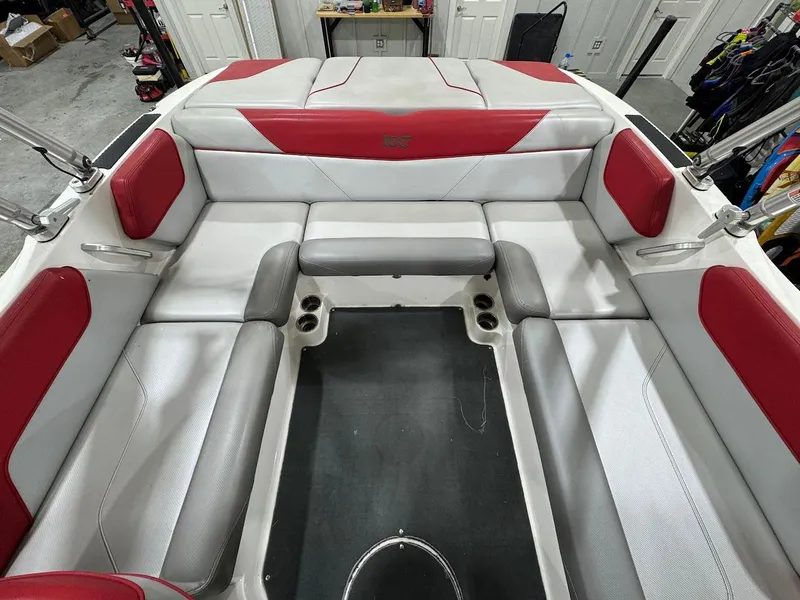 Slide: The Image of Interior of a 2016 MasterCraft NXT22 boat with red and white seating. - 12
