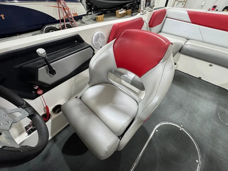 Slide: The Image of 2016 MasterCraft NXT22 interior with red and gray seating, steering wheel, and control panel. - 15