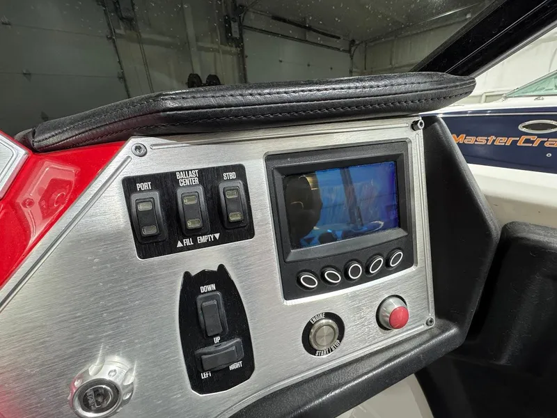 Slide: The Image of Control panel of a 2016 MasterCraft NXT22 boat with switches and display screen. - 19