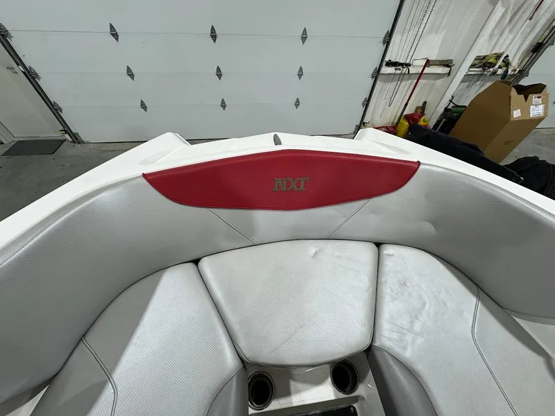Slide: The Image of Interior of 2016 MasterCraft NXT22 boat with white and red seating. - 21