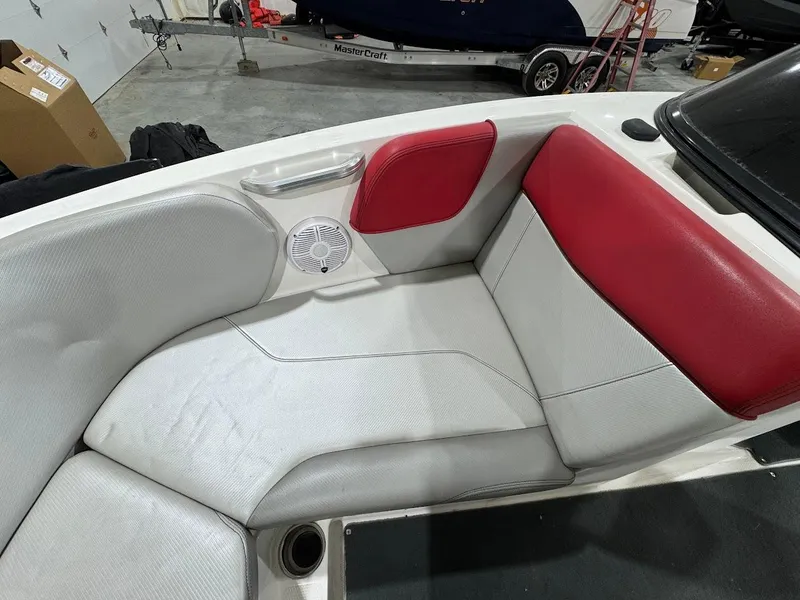 Slide: The Image of 2016 MasterCraft NXT22 boat interior with red and white seating and speaker. - 22