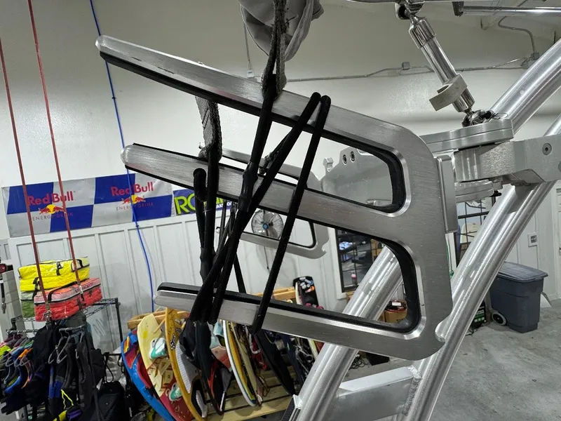 Slide: The Image of 2016 MasterCraft NXT22 wakeboard rack in a garage with equipment and Red Bull banners. - 23