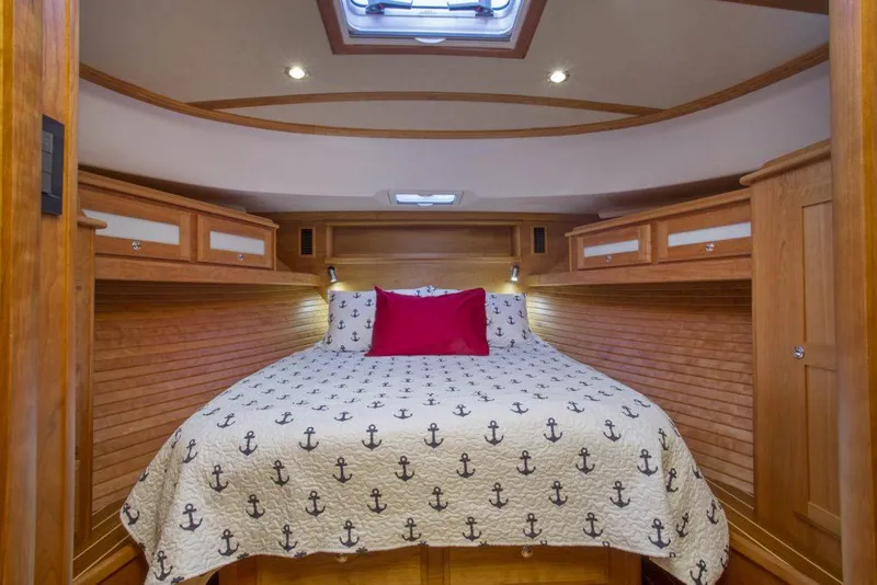 Slide: The Image of Luxurious cabin interior of 2025 Sabre 45 Salon Express with nautical-themed bedding. - 6