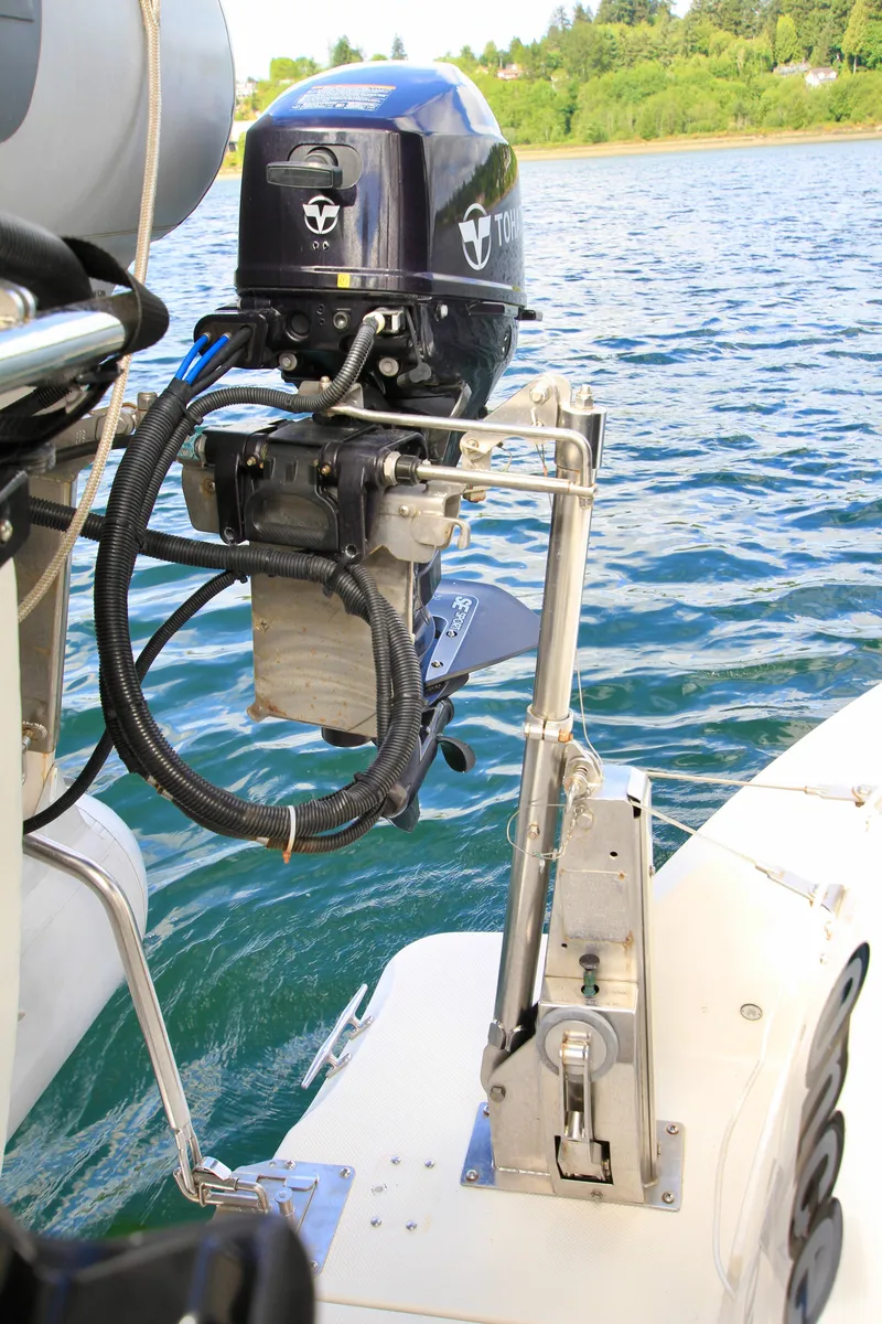 Slide: The Image of Outboard motor on a 2006 Meridian 341 Sedan, docked on a serene lake. - 10