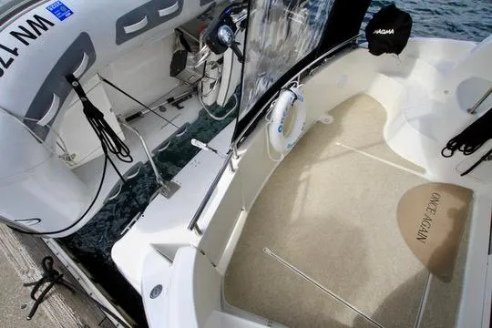 Slide: The Image of 2006 Meridian 341 Sedan boat interior with steering wheel and deck view. - 17