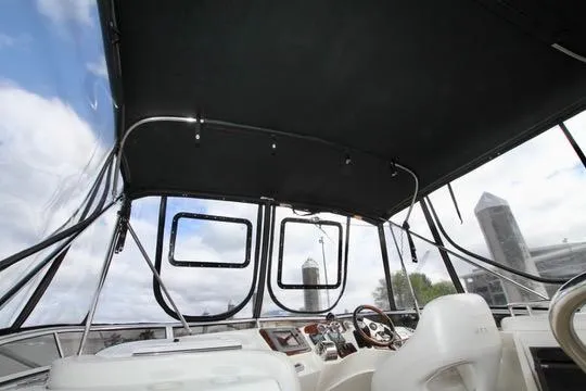 Slide: The Image of Interior view of a 2006 Meridian 341 Sedan boat cockpit with steering wheel and canopy. - 21