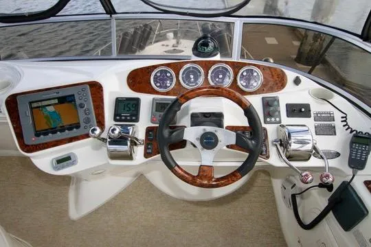 Slide: The Image of 2006 Meridian 341 Sedan helm with navigation controls and wood accents. - 25