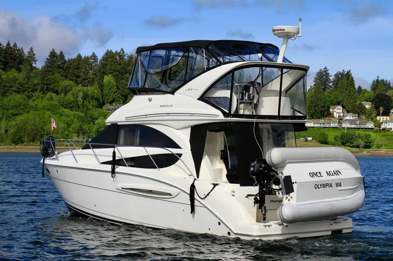 Slide: The Image of 2006 Meridian 341 Sedan yacht on water, lush green background, clear sky. - 3