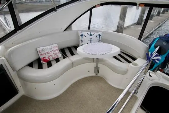 Slide: The Image of 2006 Meridian 341 Sedan interior with curved seating, nautical decor, and a small table. - 31