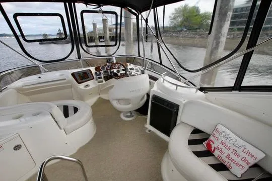 Slide: The Image of 2006 Meridian 341 Sedan boat interior with helm, seating, and waterfront view. - 32