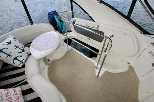 Slide: The Image of 2006 Meridian 341 Sedan interior with seating, nautical pillows, and water view. - 33