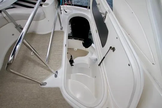 Slide: The Image of 2006 Meridian 341 Sedan boat interior storage compartment with open hatch and railing. - 34