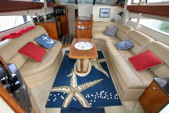 Slide: The Image of Interior of 2006 Meridian 341 Sedan yacht with beige seating and nautical-themed decor. - 35