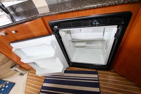 Slide: The Image of Open refrigerator in 2006 Meridian 341 Sedan yacht kitchen with wooden cabinetry. - 44