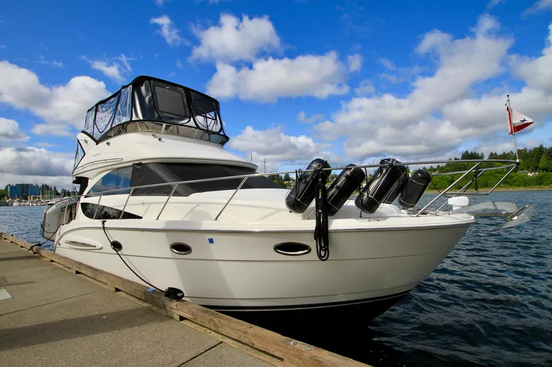 Slide: The Image of 2006 Meridian 341 Sedan yacht docked by the water under a blue sky. - 6