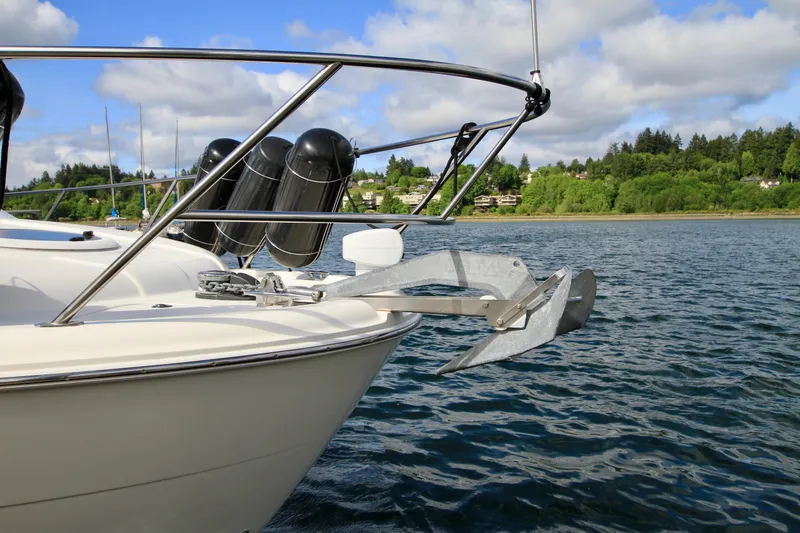 Slide: The Image of 2006 Meridian 341 Sedan boat anchored on a scenic lake with lush green shoreline. - 7