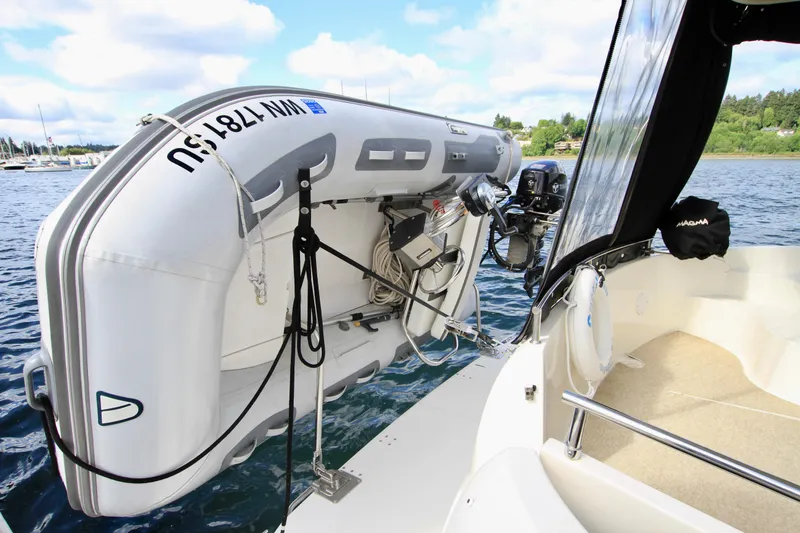 Slide: The Image of 2006 Meridian 341 Sedan with mounted inflatable boat on calm water. - 9