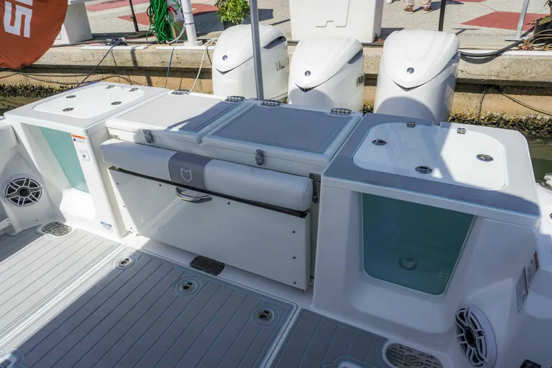 Slide: The Image of 2026 Sea Fox 368 Commander boat deck with storage compartments and outboard motors. - 11