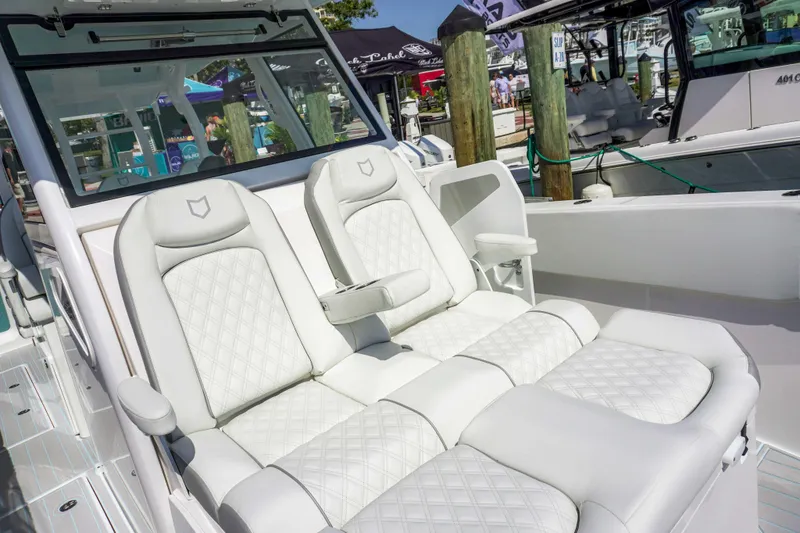 Slide: The Image of 2026 Sea Fox 368 Commander boat with luxurious white seating at a marina. - 16