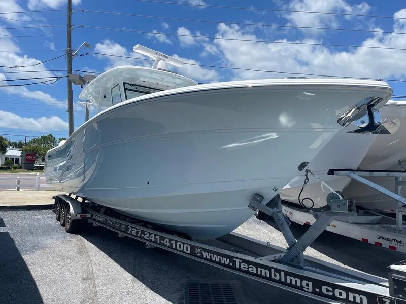 Slide: The Image of 2026 Sea Fox 368 Commander boat on trailer under clear blue sky. - 21
