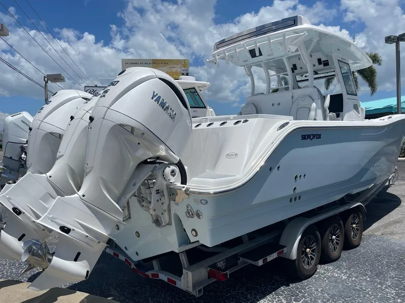 Slide: The Image of 2026 Sea Fox 368 Commander boat with Yamaha engines on a trailer, under a clear blue sky. - 22