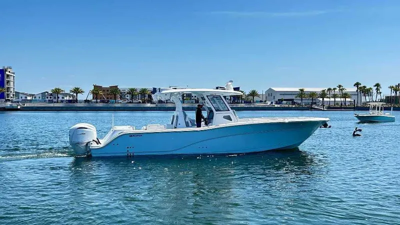 Slide: The Image of 2026 Sea Fox 368 Commander boat cruising on a sunny day in a coastal area. - 3