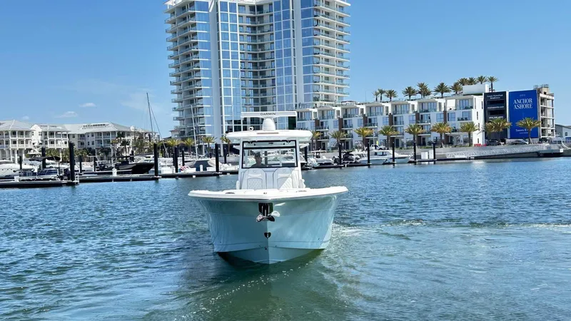 Slide: The Image of 2026 Sea Fox 368 Commander boat cruising near modern waterfront buildings. - 5