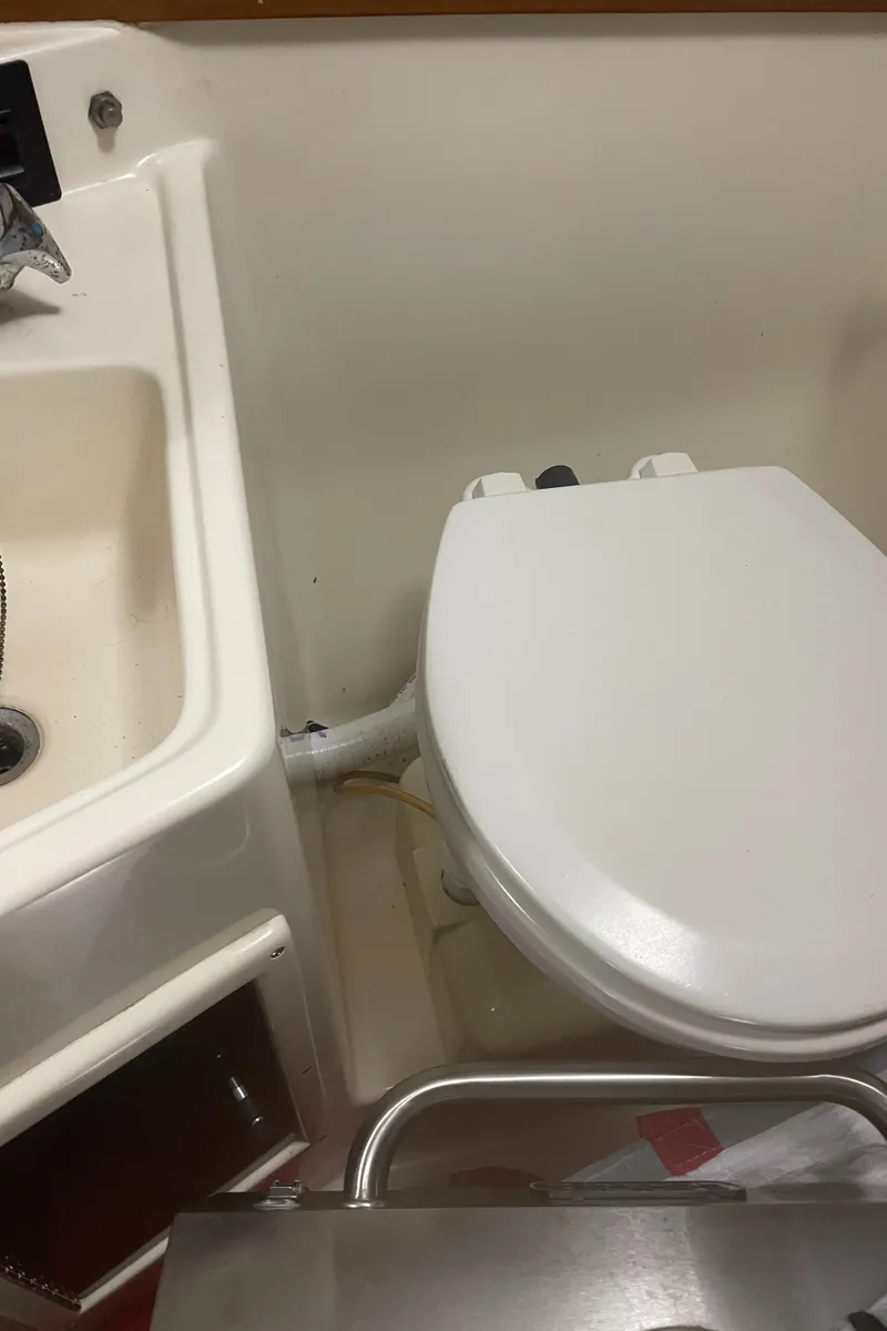 Slide: The Image of 1990 Tiara Yachts 3100 Open bathroom with sink and toilet. - 15