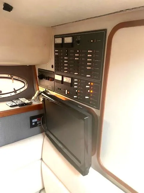 Slide: The Image of 1990 Tiara Yachts 3100 Open interior with control panel and TV. - 16