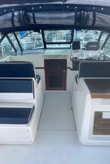 Slide: The Image of 1990 Tiara Yachts 3100 Open interior with seating and helm, showcasing classic design. - 24