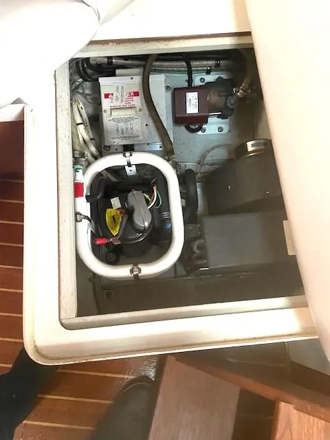 Slide: The Image of Engine compartment of a 1990 Tiara Yachts 3100 Open, showcasing mechanical components. - 26