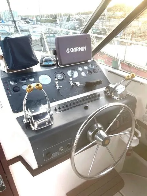 Slide: The Image of 1990 Tiara Yachts 3100 Open helm with Garmin navigation system and dual throttle controls. - 5