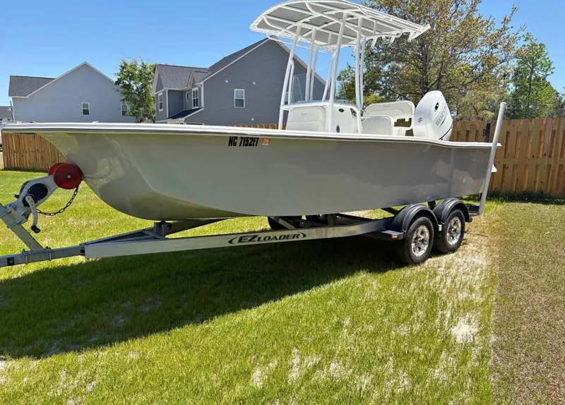 Slide: The Image of 2021 Savannah SS21 boat on trailer in residential yard. - 0
